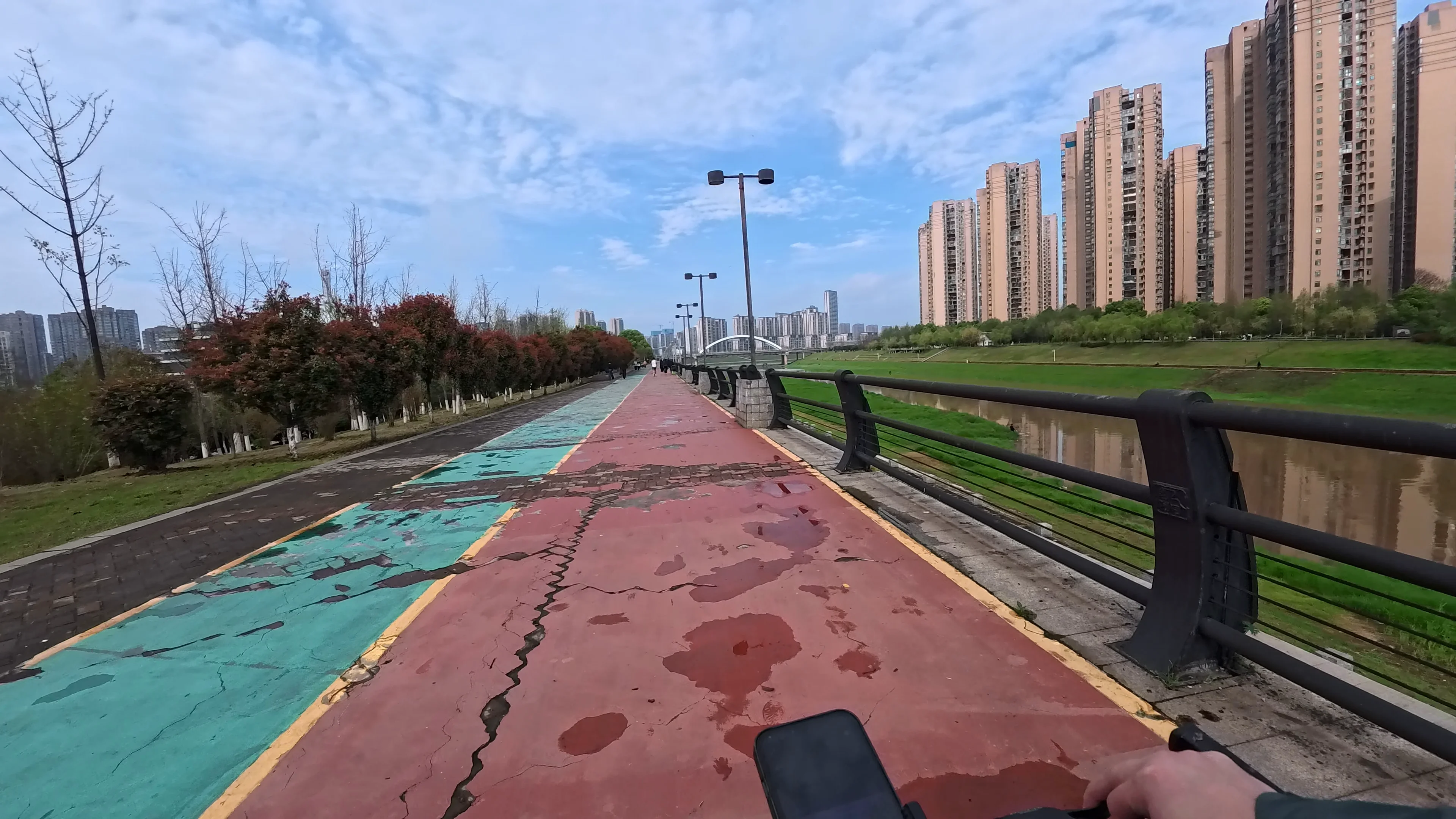 Riverside cycling path with skyline views in the distance